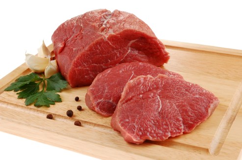 Raw beef on cutting board isolated